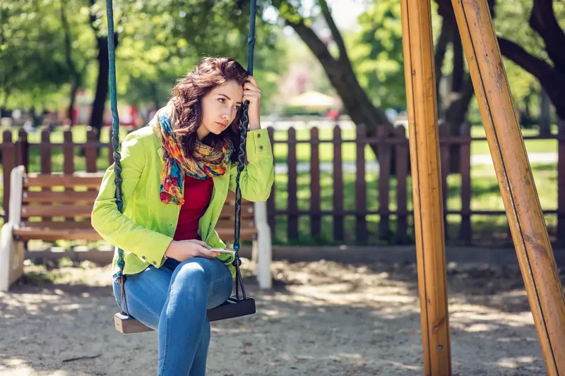 Young woman sitting alone and depressed