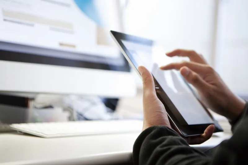 Person using a tablet at their desk