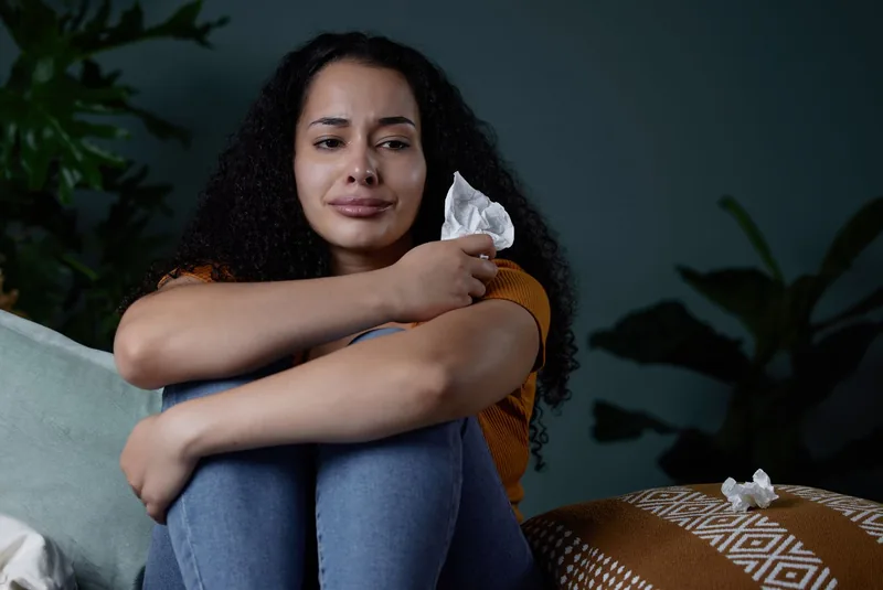 Shot of a young woman feeling unhappy at home