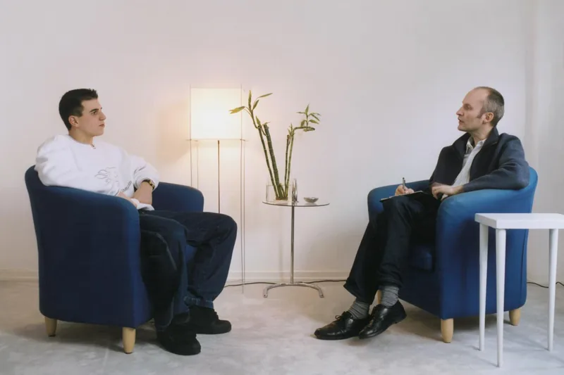 Man Sits With Therapist