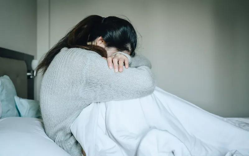 depressed person on bed