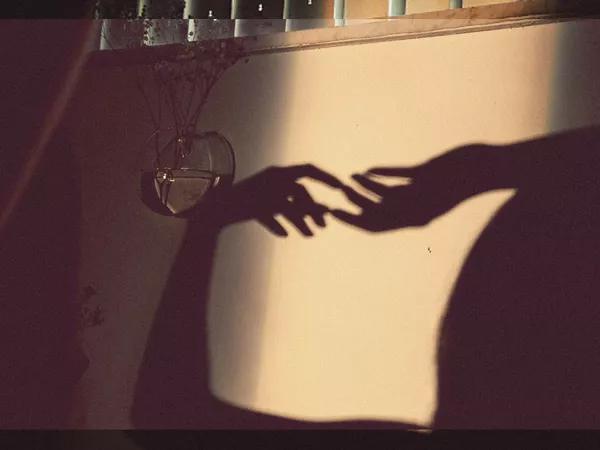 Silhouette of two hands touching