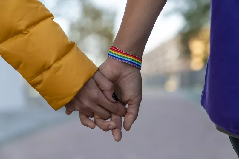 Close-up of two lesbian couple holding hands in a park