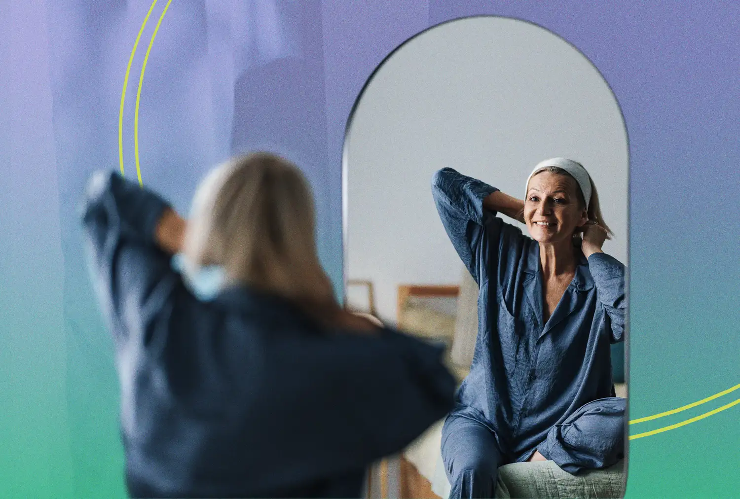 A woman adjusts her headband while looking into a mirror with a modern gradient background