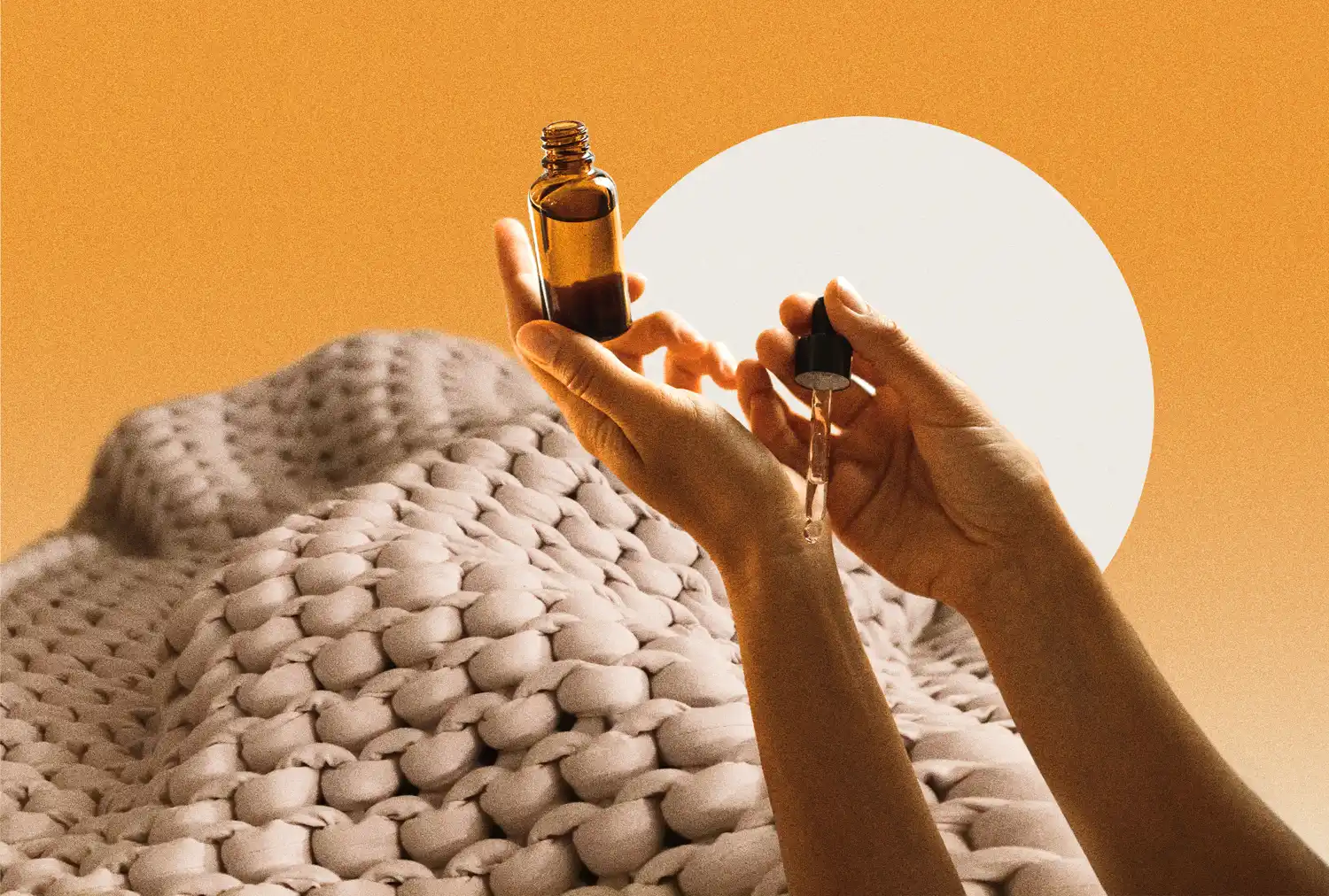 Hands holding a bottle and dropper above a textured blanket in a wellnessthemed arrangement