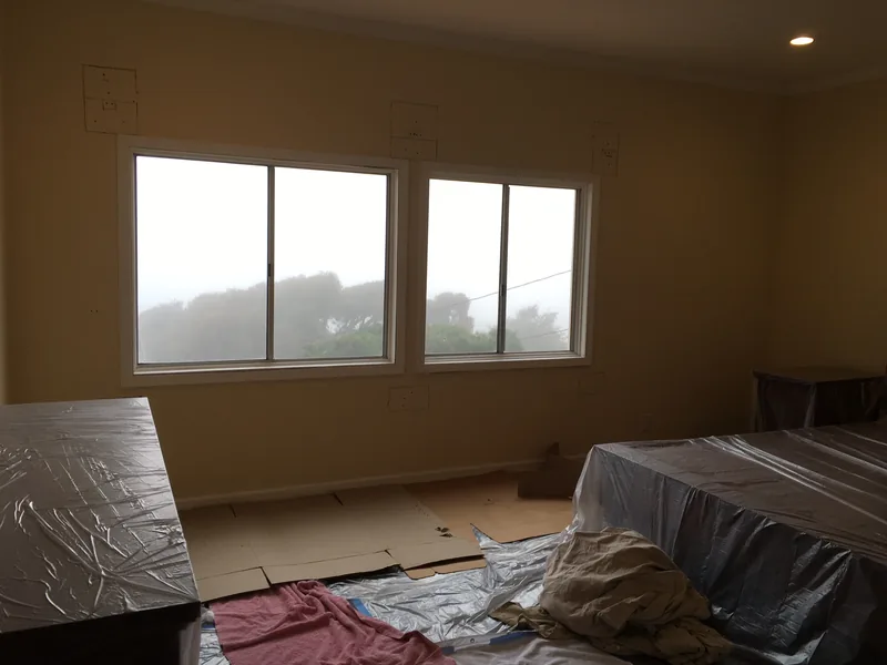 Construction progress showing new sliding door installation with temporary support wall