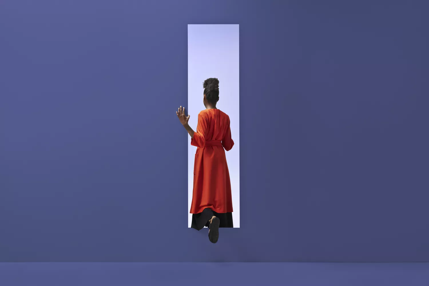 Woman walking through an opening in the wall