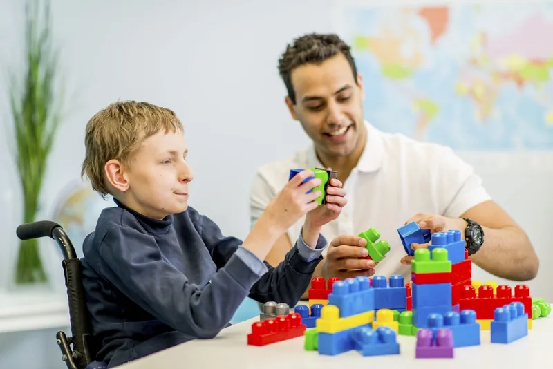 Applied behavior analysis with boy in wheelchair.