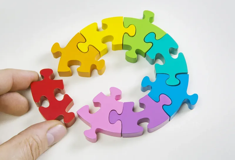 Person putting together puzzle pieces