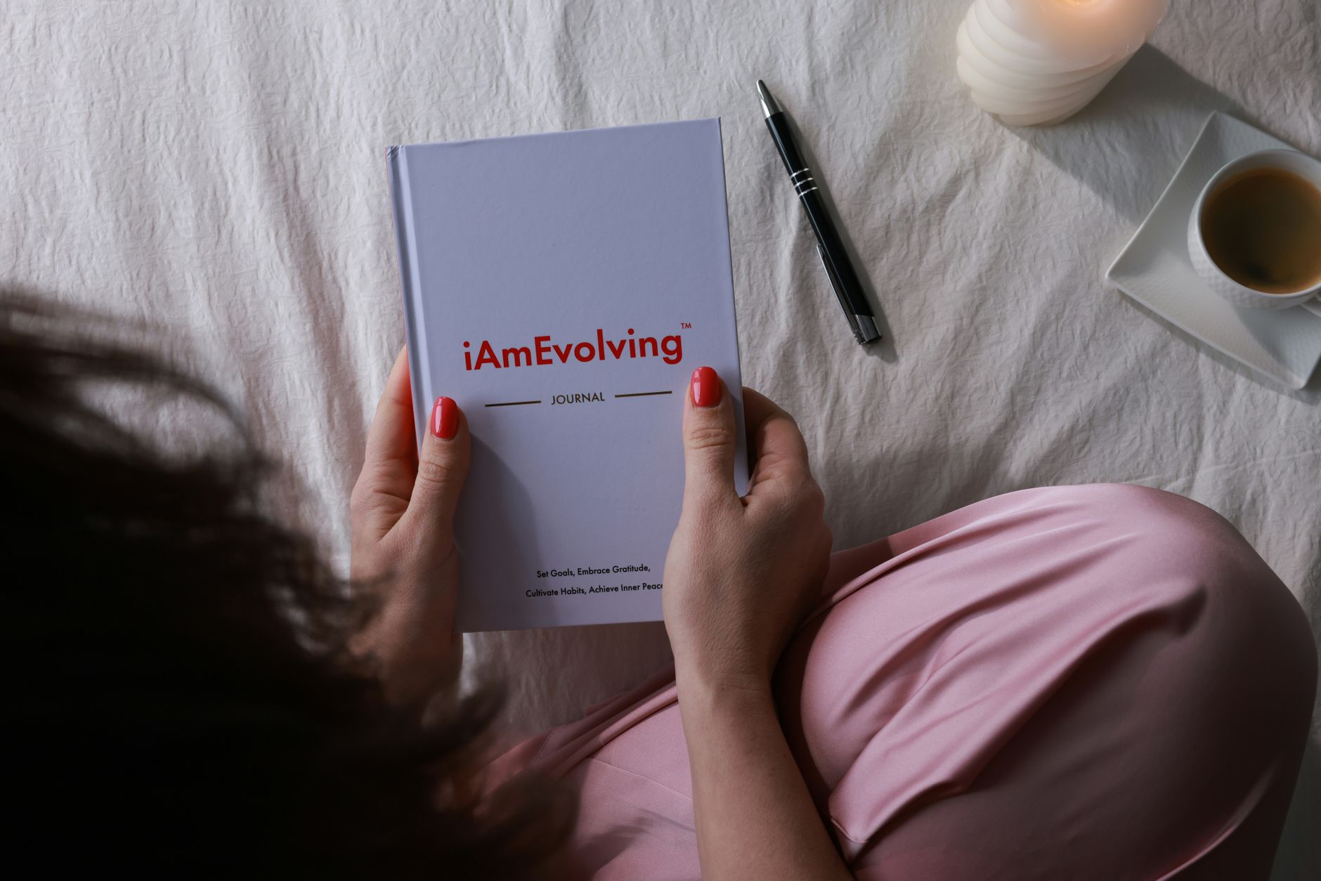 A serene morning routine featuring journaling with a candle and coffee.
