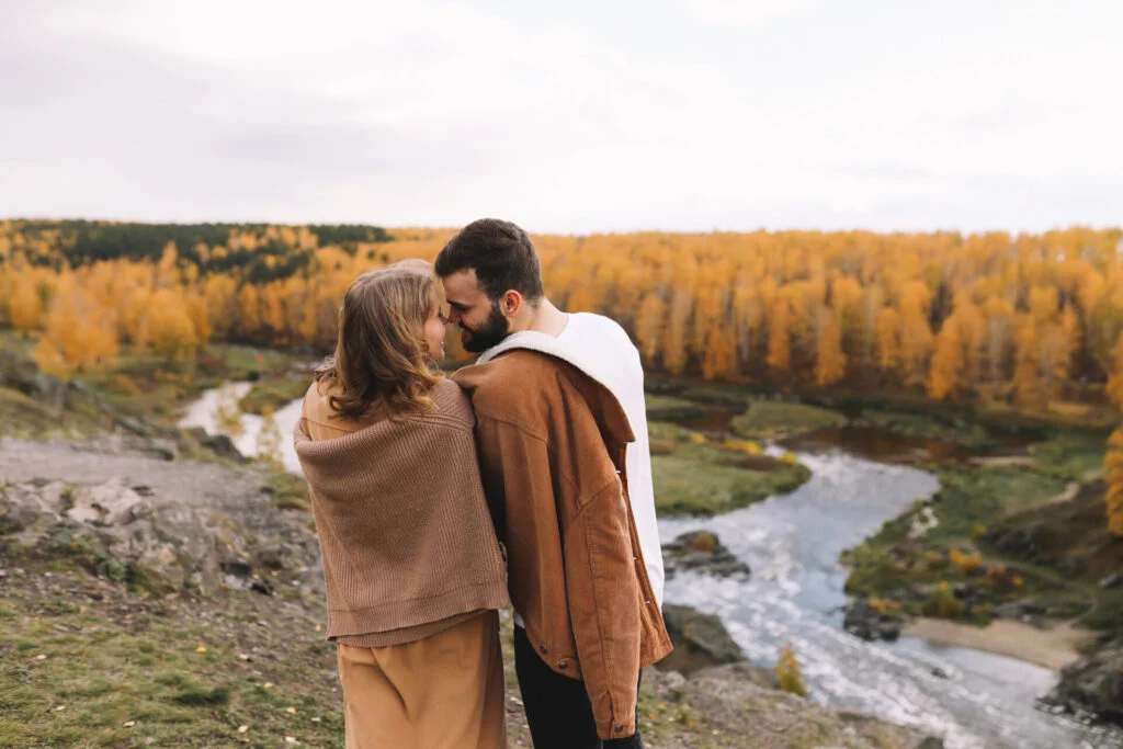 Couple hiking through fall foliage